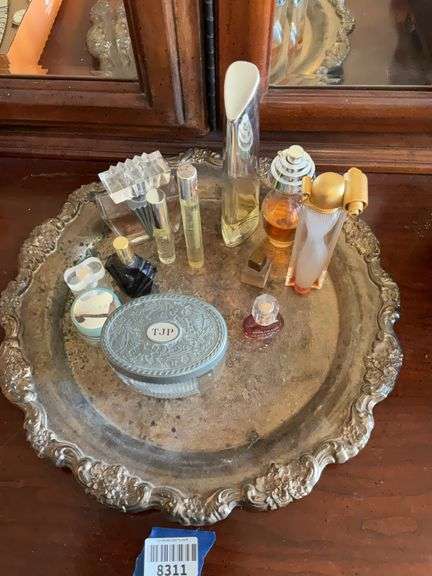 Perfume bottles and dresser box on round tray