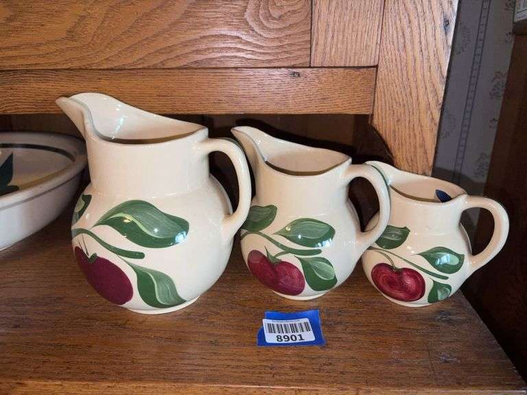 Three WATT ware pottery apple pattern graduated pitchers