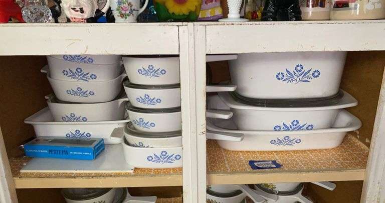 Contents of shelf: vintage Corning Blue Cornflower baking dishes, saucepans, and detachable handle