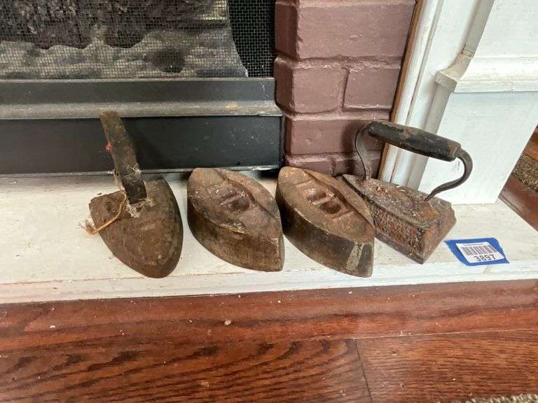 Four cast sad irons