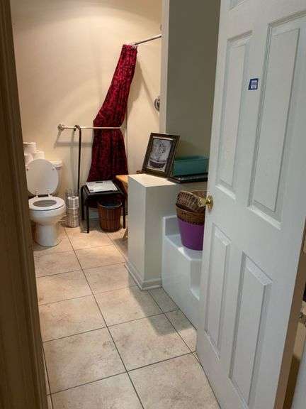 Contents of bathroom: baskets, rug, framed prints, folding stand, wicker stand, bath scale, linens, misc