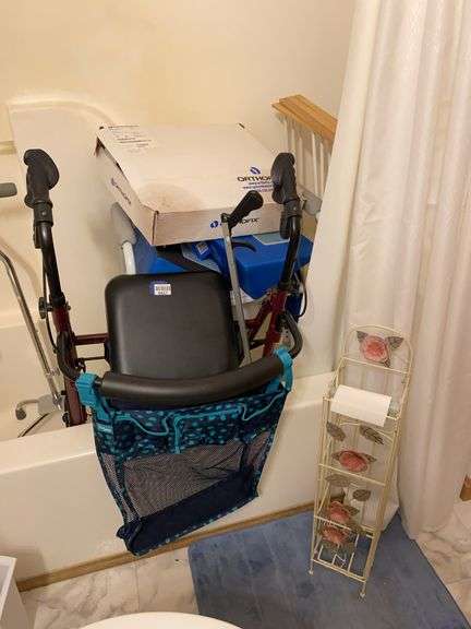 Contents of bathtub: bath tissue stand, roller walker, grabber, walker, drying rack, quad cane, spinal stimulator