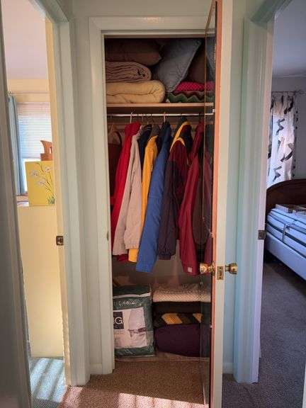 Contents of closet: blankets, afghans, throw pillows, jackets, comforters