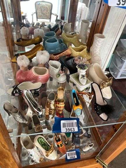 Contents of shelf: shoes in ceramic, porcelain, misc