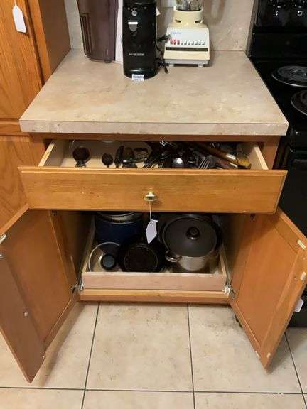 Contents of drawer and cupboard: flatware, hand mixer, cookware, baking pans