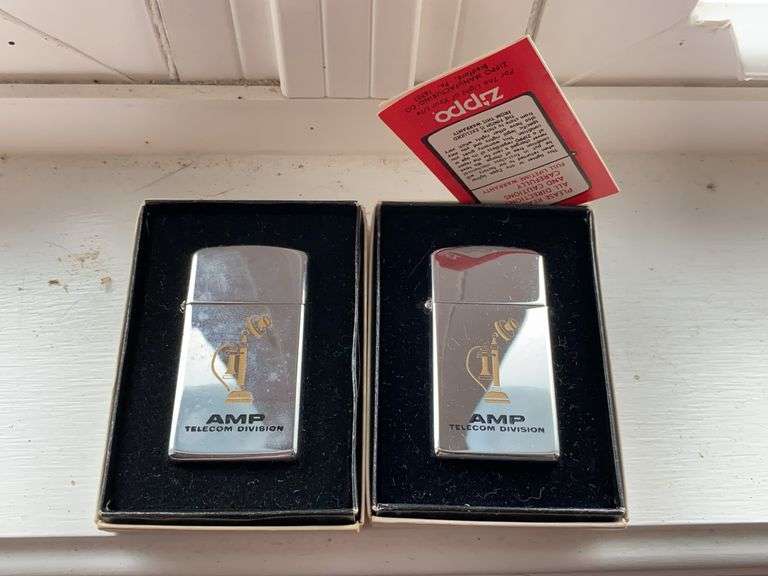 Two Zippo advertising cigarette lighters in boxes: AMP Telecom Division