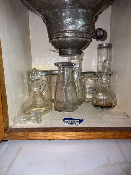 Glass syrup pitcher, two cruets, and kitchen cabinet spice jars