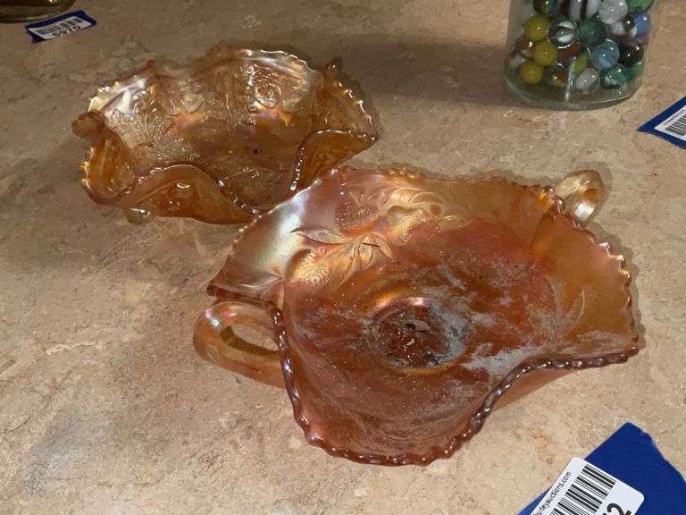 Two pcs marigold carnival glass: Fenton Strawberry bonbon, and Panther footed sauce