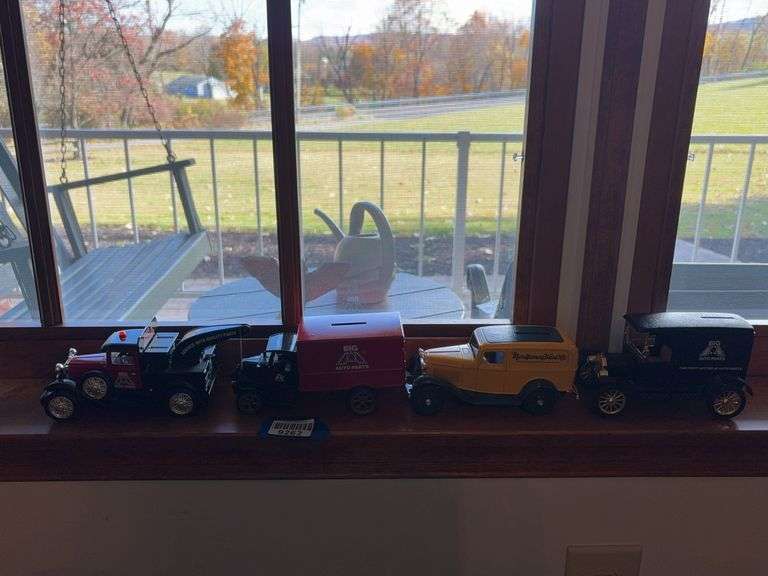 Four diecast model truck banks