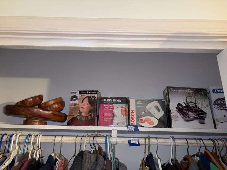 Contents of shelf: monkey pod wood bowls, cordless neck massager, travel steamer, hand mixer, teaset, Proctor Silex hotplate