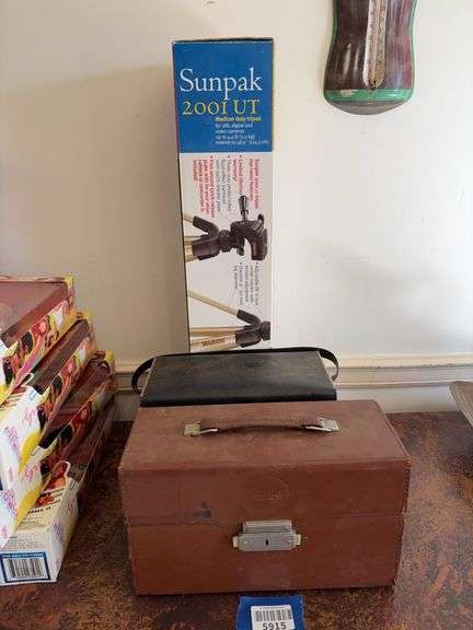 Vintage movie camera, tripod in box