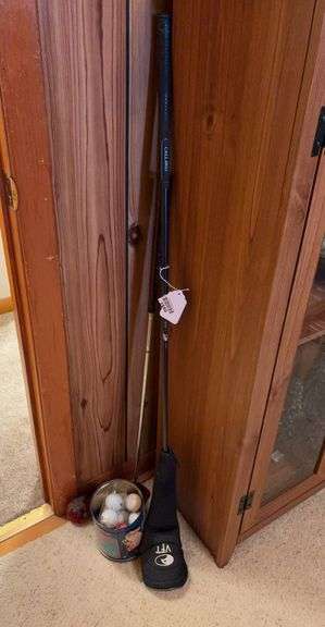 Golf clubs and tin of balls