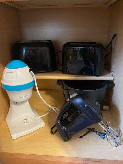 Contents of cupboard: toasters, hand mixer, snow cone maker, deep fryer