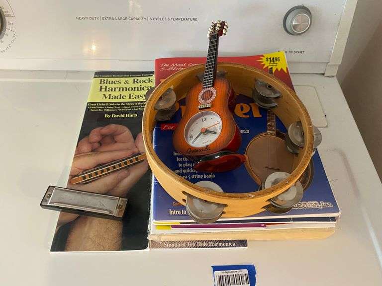 Guitar novelty clock, tambourine, harmonica, music instruction books