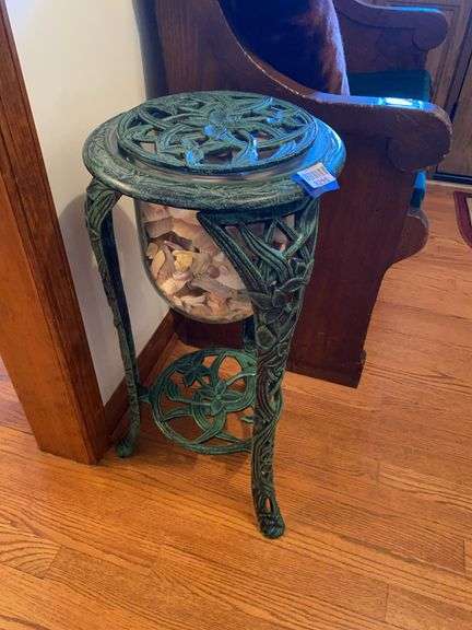 2-tier cast metal stand w/ globe filled w/ seashells under top