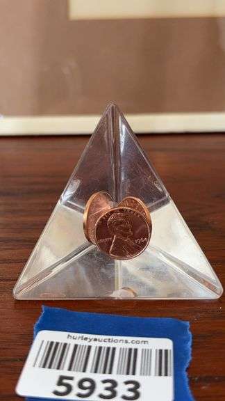 Three 1964 Lincoln cents encased in paperweight