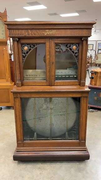 REGINA 12 disc coin op upright music box in quarter sawn oak case 35.5x23x67