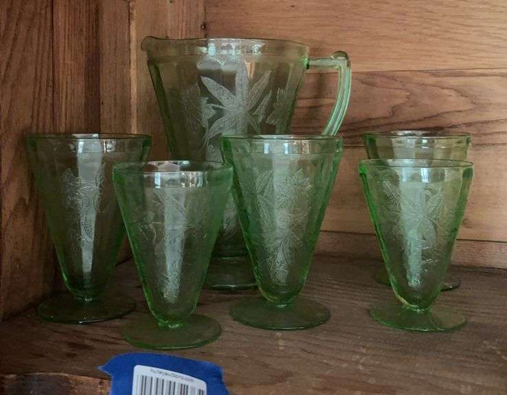 Poinsettia green depression glass pitcher and five footed glasses