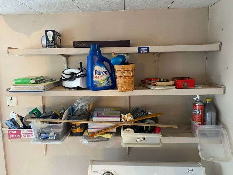 Contents of three shelves: iron, laundry detergent, Scrabble game, basket, household items