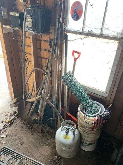 Propane tank, scythe, garden tools, plastic buckets, JVC CD/cassette deck, Holmes electric heater, misc