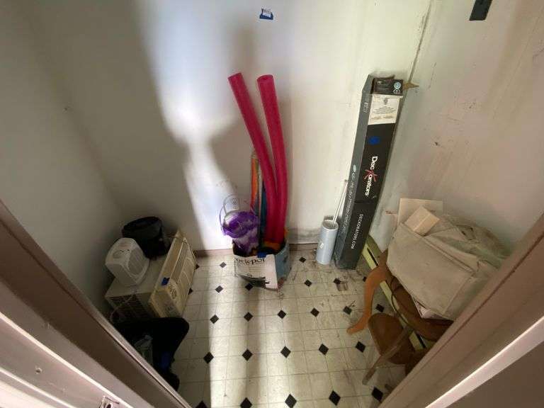 Contents of closet: stylist sink, Maytag window AC unit, electric heater, fan, sewing machine, pool noodles, wooden stand, misc
