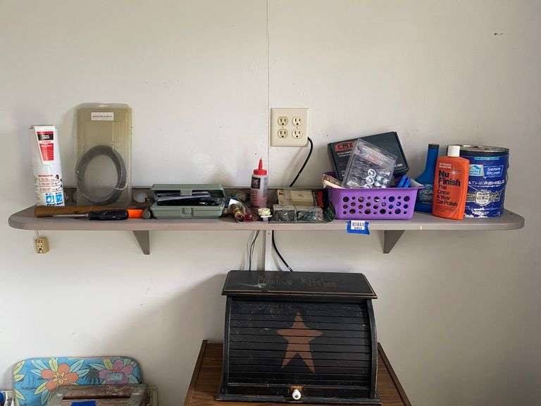 Contents of shelf and on floor in corner: tools, folding chair, wooden step ladder, misc