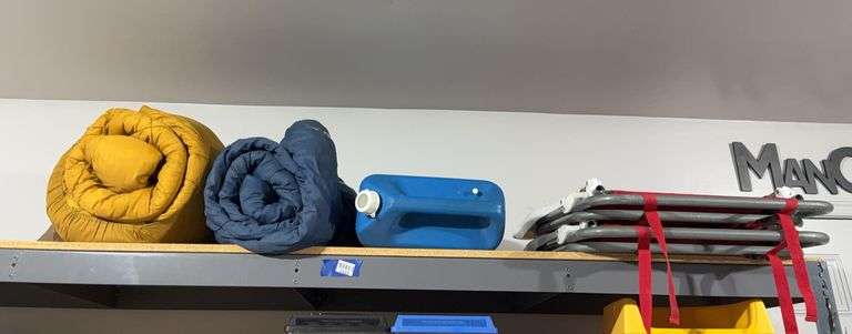 Contents of garage shelf - two sleeping bags, folding chair, cooler