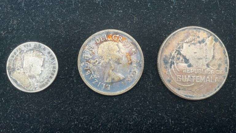 Three foreign coins: 1910 Canada dime, 1957 Canada quarter, 1943 Guatemala 25 Centavos