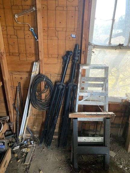 Folding sawhorse, aluminum stepladder, pair of speaker stands, extension cord, paint roller, fluorescent tubes, misc
