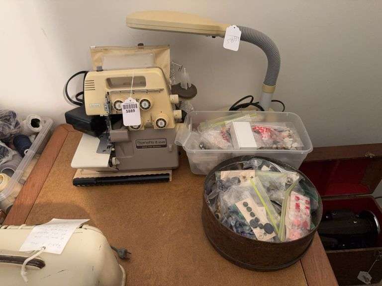 Bernina Bernette 334D overlock sewing machine, adjustable light, and button containers