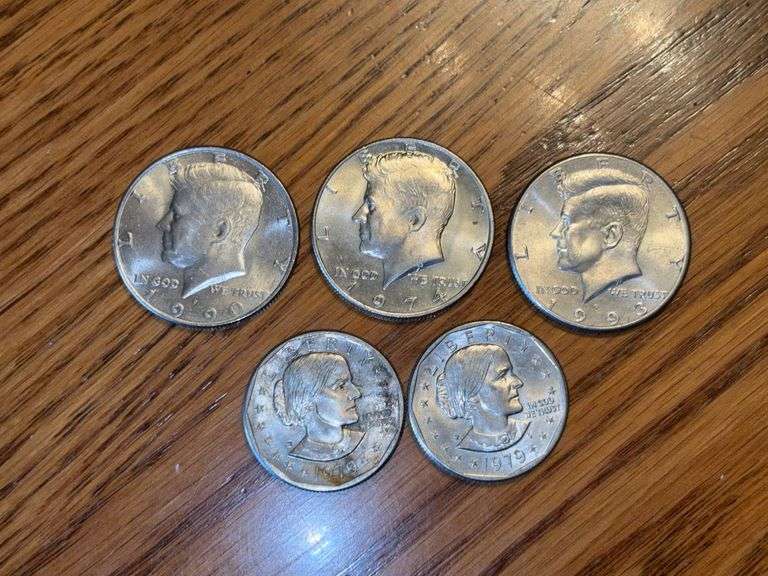 Coins: three Kennedy half dollars: 1974, 1990, 1993, and two 1979 Susan B. Anthony dollars