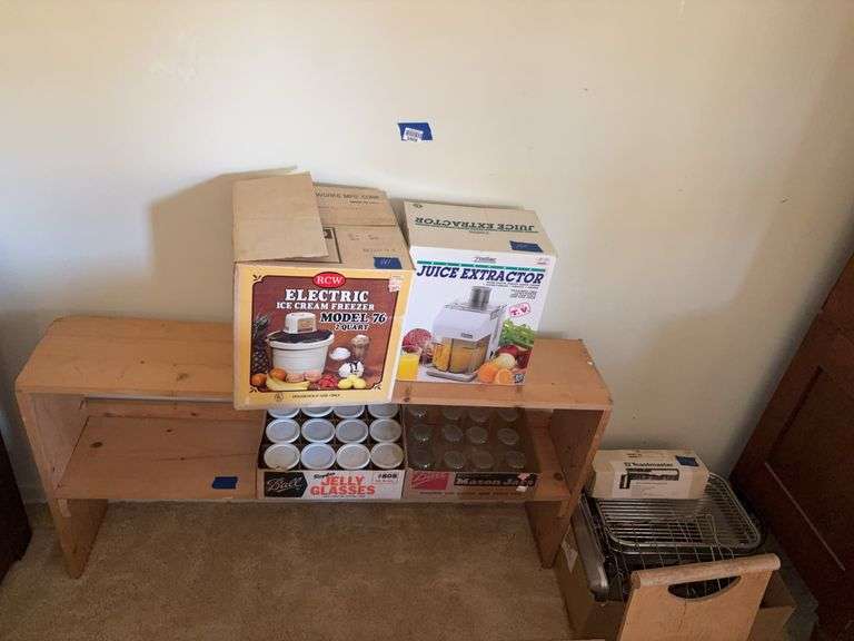 Shelf unit and contents on and beside: jelly jars, ice cream freezer, juice extractor, misc