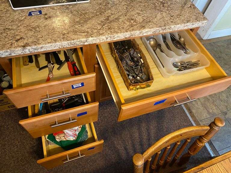 Contents of four drawers: knives, utensils, kitchen linens, flatware