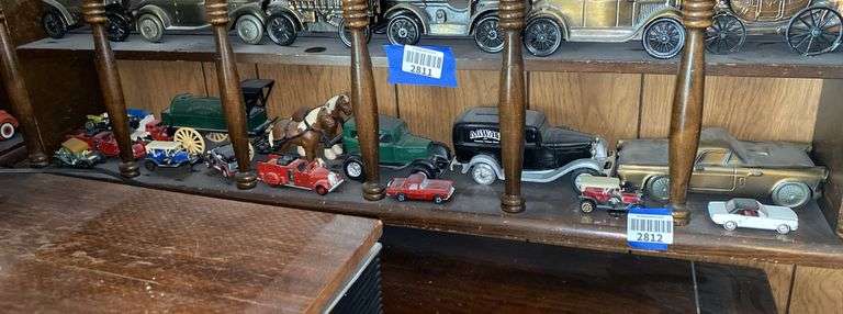 Contents of one what-not shelf - cast metal vehicle replicas, fire engine & hose company horse drawn wagon, some die cast