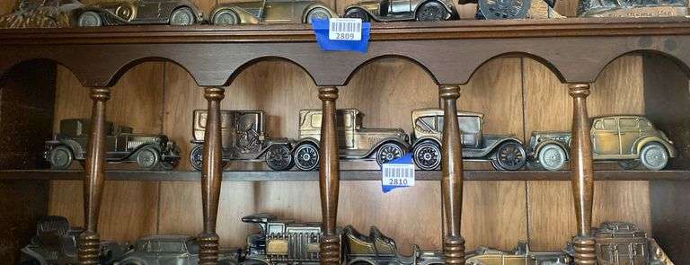 Contents of one what-not shelf - cast metal vehicle replicas