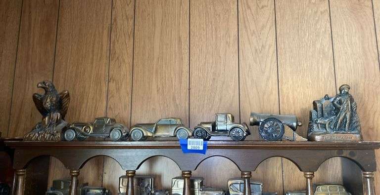 Contents of one what-not shelf - Cast metal Minute Man, Eagle, Cannon, three vehicle replicas