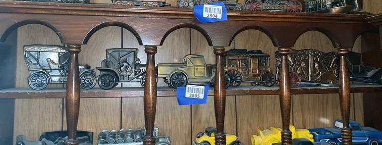 Contents of one what-not shelf - stage coach, circus wagon, old car replicas