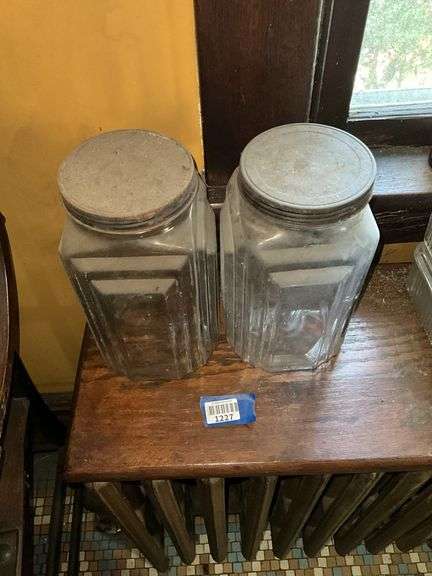 Two square patterned storage jars w/ tin lids