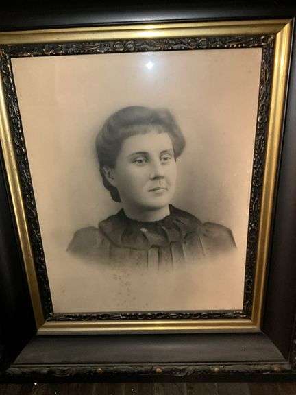 Black and gilt Victorian frame holding solar enlargement portrait of young woman