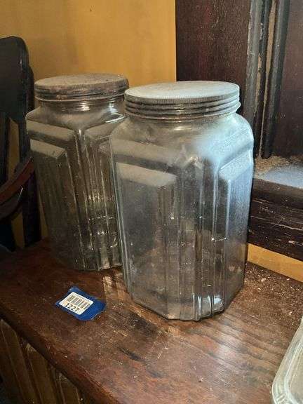 Two square patterned storage jars w/ tin lids