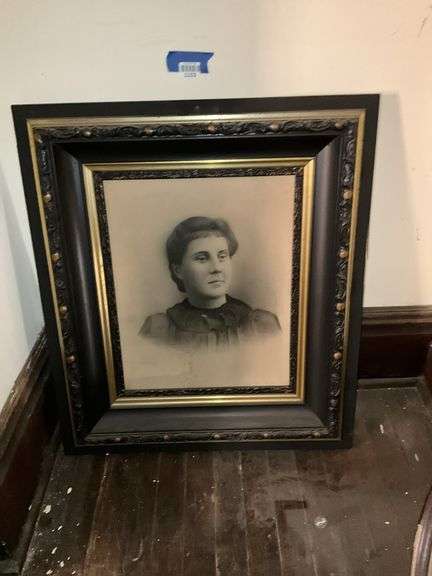 Black and gilt Victorian frame holding solar enlargement portrait of young woman