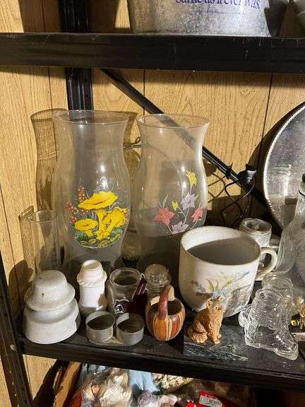 Contents of two shelves: food grinder, household and decor items