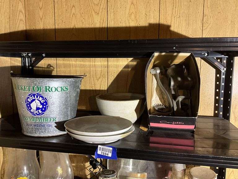 Contents of two shelves: food grinder, household and decor items
