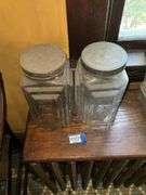 Two square patterned storage jars w/ tin lids
