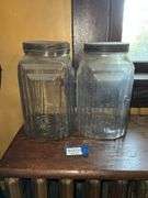 Two square patterned storage jars w/ tin lids
