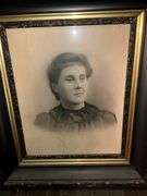 Black and gilt Victorian frame holding solar enlargement portrait of young woman