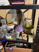 Contents of two shelves: food grinder, household and decor items