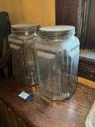 Two square patterned storage jars w/ tin lids