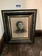 Black and gilt Victorian frame holding solar enlargement portrait of young woman
