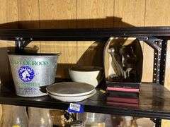 Contents of two shelves: food grinder, household and decor items